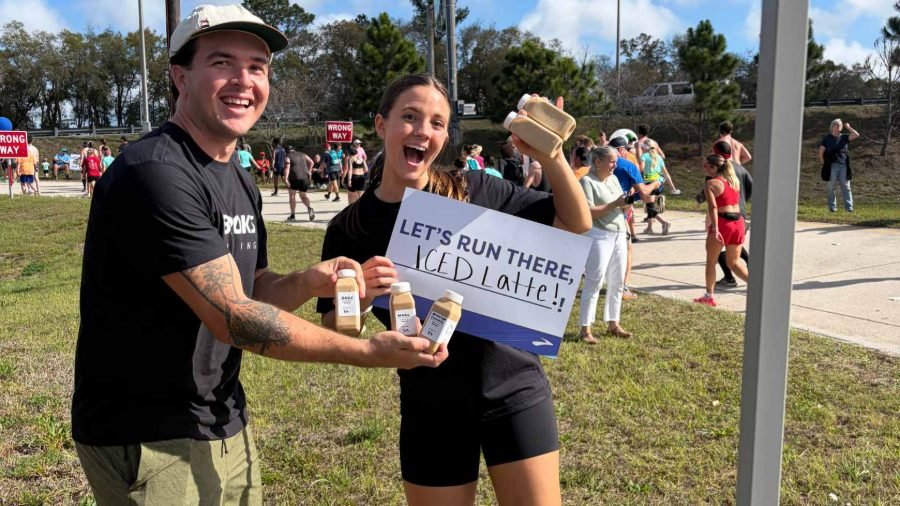Tony and Sydne handing out bottled lattes at a Brooks running brand activation