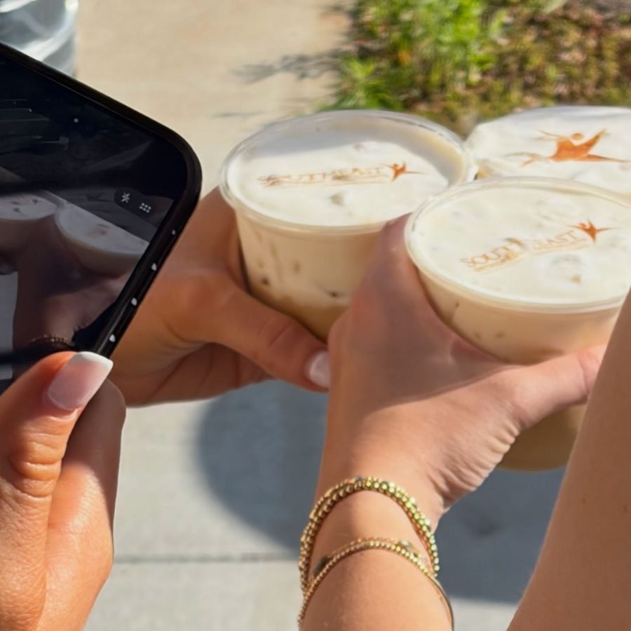 Three iced lattes with Southeast Orthopedic Specialists logos printed in the foam, raised in a cheers
